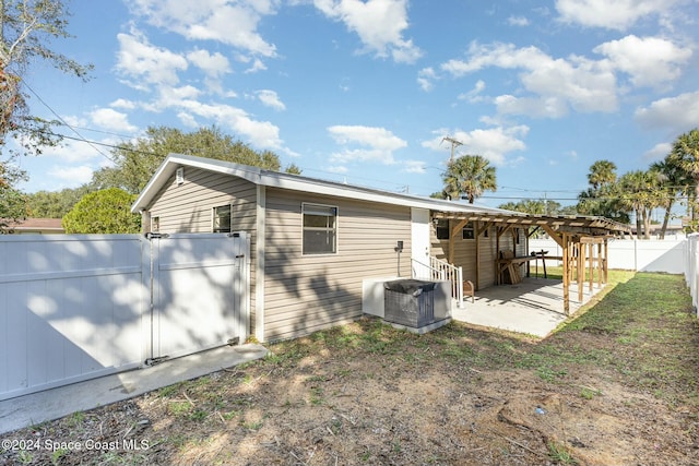 view of side of home featuring central AC unit