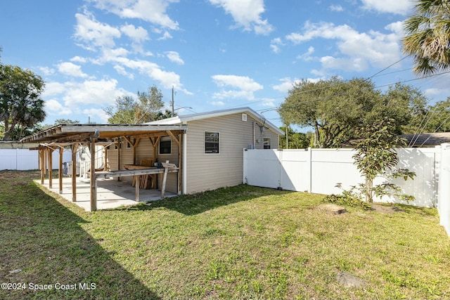 back of property featuring a lawn and a patio