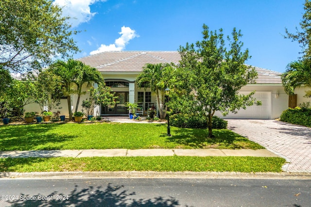 obstructed view of property with a garage and a front yard