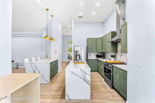 kitchen with green cabinets, pendant lighting, stainless steel appliances, and sink