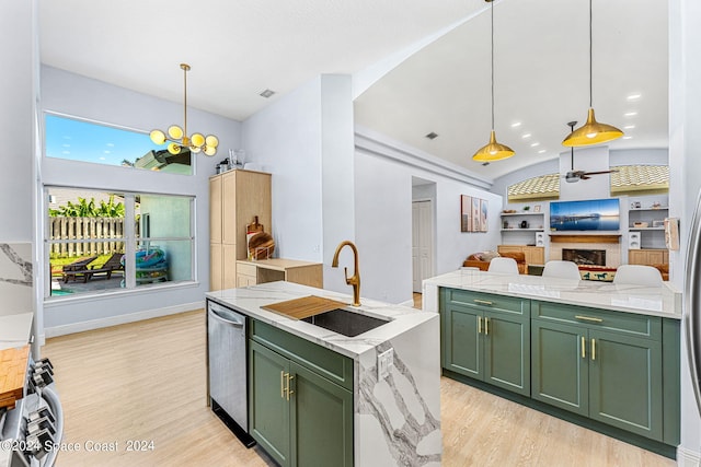 kitchen with sink, built in features, stainless steel dishwasher, and green cabinetry