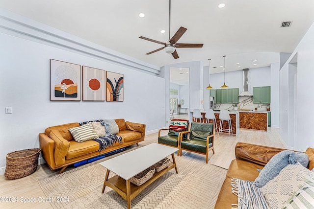 living room featuring ceiling fan and light hardwood / wood-style floors