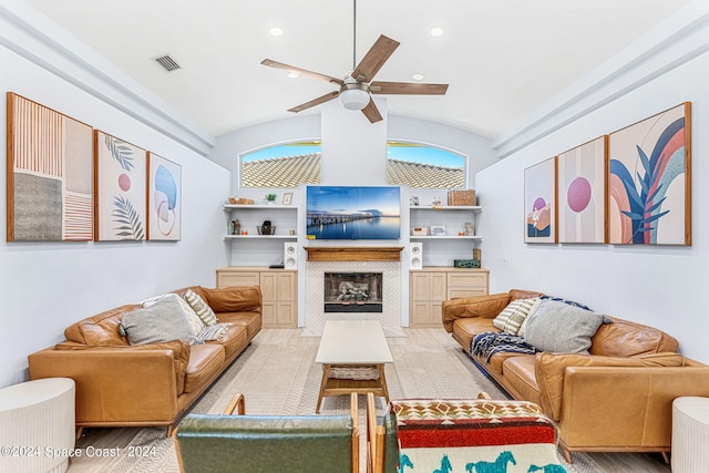 living room with ceiling fan, built in features, and lofted ceiling