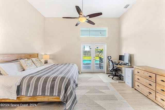 bedroom featuring access to exterior, french doors, light hardwood / wood-style floors, and ceiling fan