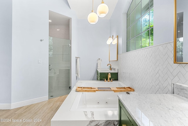 bathroom featuring hardwood / wood-style flooring, vanity, and independent shower and bath