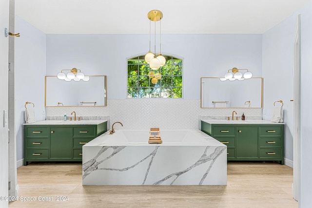 bathroom featuring a washtub, vanity, and wood-type flooring