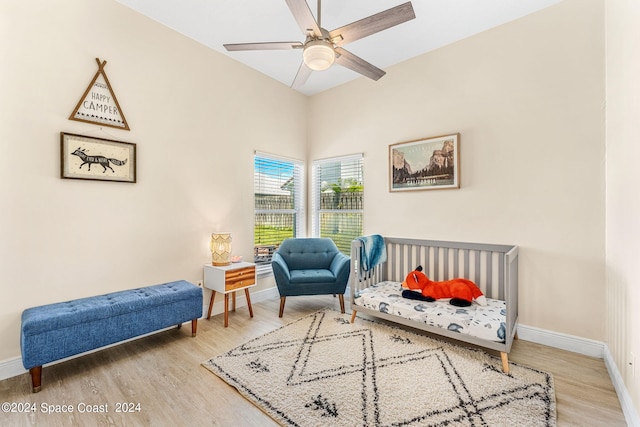 sitting room with hardwood / wood-style floors and ceiling fan