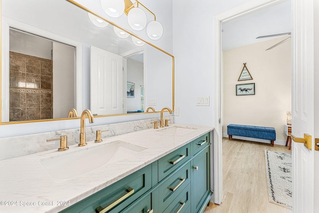 bathroom featuring wood-type flooring, vanity, and ceiling fan