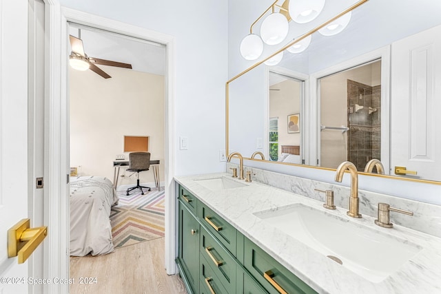 bathroom featuring ceiling fan, hardwood / wood-style floors, and vanity