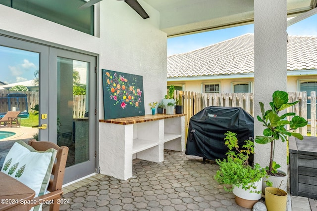 view of patio / terrace with a grill and ceiling fan