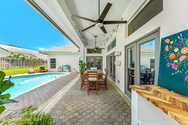 view of pool with a patio and ceiling fan