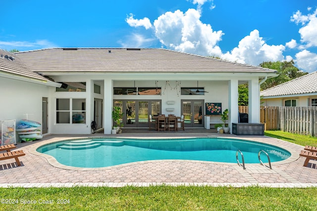 view of swimming pool with french doors, ceiling fan, and a patio area