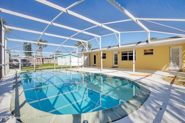 view of swimming pool with a lanai and a patio