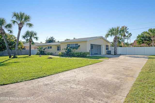 single story home with a front yard and a garage