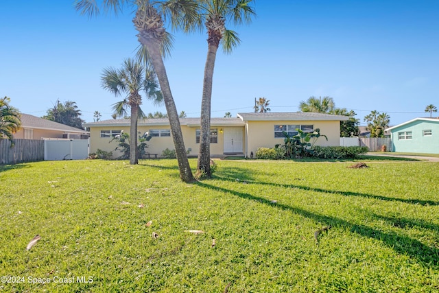 single story home featuring a front lawn