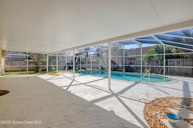 view of swimming pool featuring a lanai and a patio area