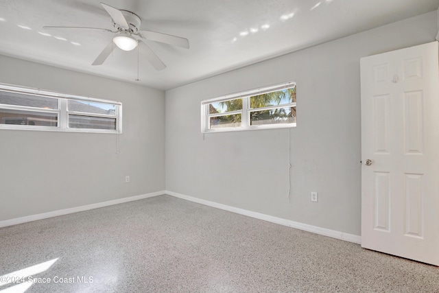 unfurnished room with ceiling fan