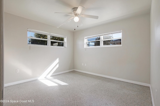 unfurnished room featuring plenty of natural light and ceiling fan