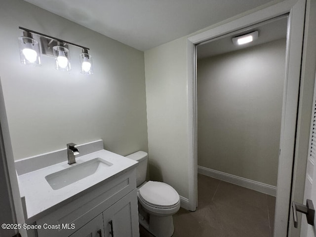 bathroom featuring tile patterned flooring, vanity, and toilet