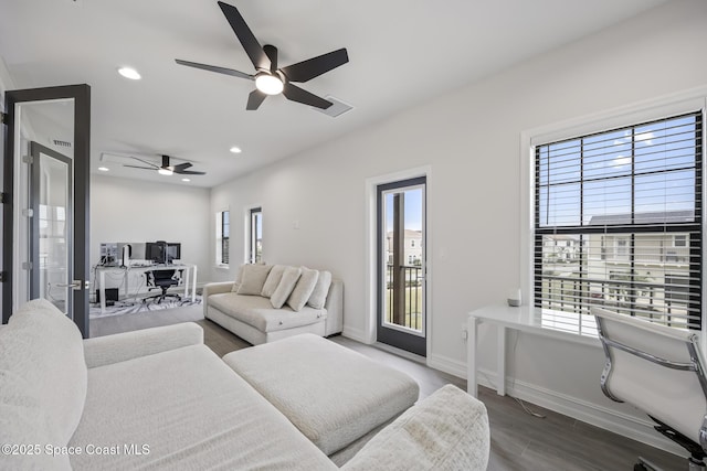 living room featuring a wealth of natural light, ceiling fan, and hardwood / wood-style flooring