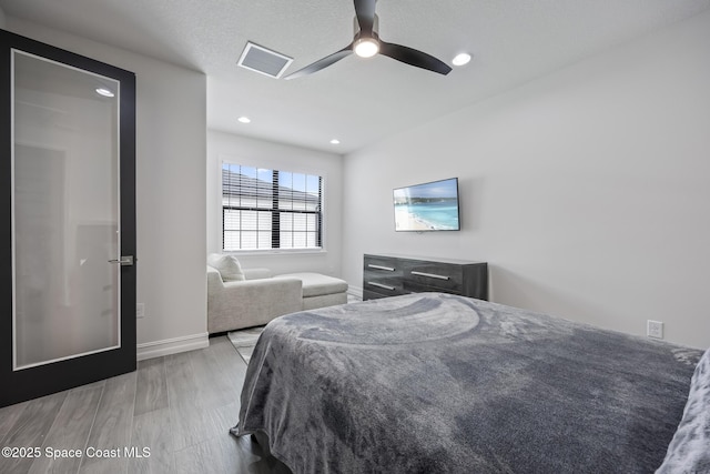 bedroom featuring ceiling fan and light hardwood / wood-style floors