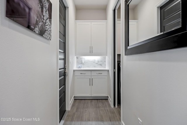 hallway with light hardwood / wood-style floors