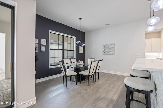 dining area with wood-type flooring