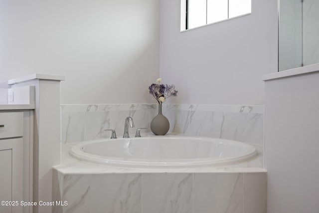 bathroom with tiled bath