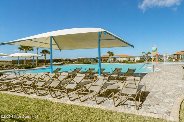 view of swimming pool featuring pool water feature and a patio area