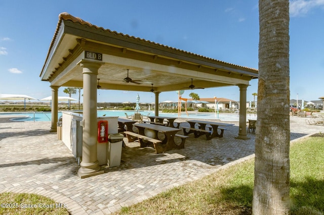 view of property's community featuring a gazebo, a water view, and a pool