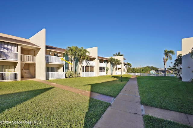 view of property's community with a lawn