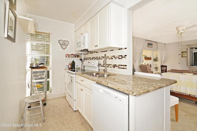 kitchen featuring ceiling fan, sink, white appliances, decorative backsplash, and white cabinets