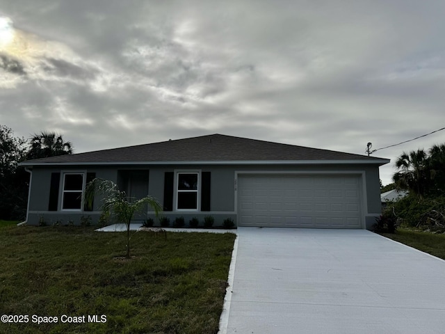 ranch-style house with a garage and a front yard