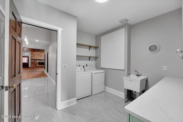 laundry room featuring washer and dryer and sink