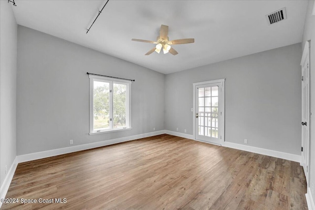 spare room featuring light hardwood / wood-style flooring and ceiling fan