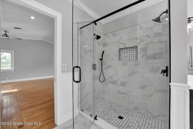 bathroom featuring ceiling fan, an enclosed shower, crown molding, and vaulted ceiling