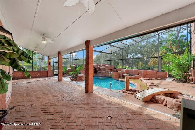 view of patio / terrace with pool water feature, ceiling fan, and glass enclosure