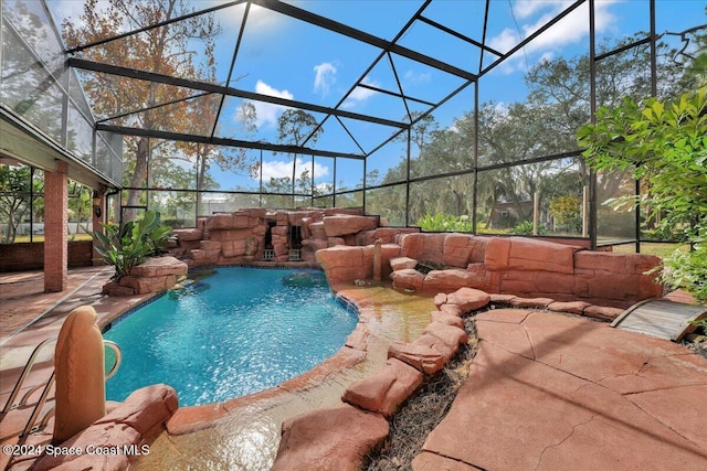 view of swimming pool with pool water feature, a patio, and a lanai