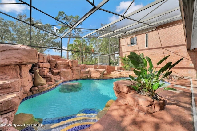 view of swimming pool featuring glass enclosure