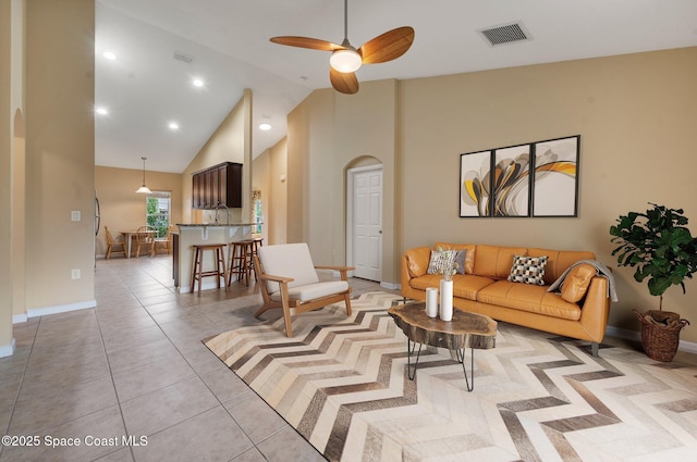 living room with high vaulted ceiling, ceiling fan, and light tile patterned flooring