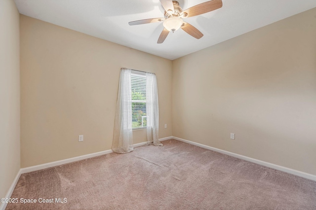 unfurnished room featuring light colored carpet and ceiling fan