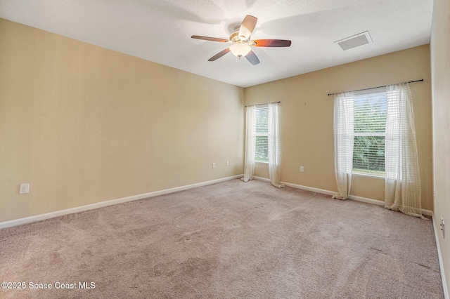 carpeted empty room featuring ceiling fan