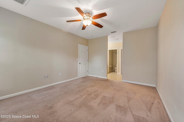 empty room featuring ceiling fan and light colored carpet