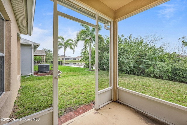 unfurnished sunroom with a water view