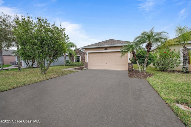 view of front of home with a front lawn and a garage