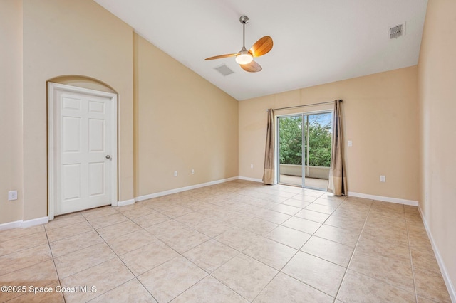 spare room with ceiling fan, light tile patterned flooring, and vaulted ceiling