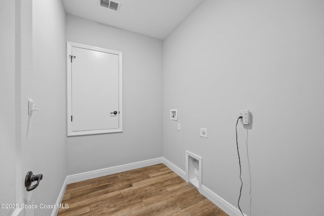 laundry area with hookup for an electric dryer, hookup for a washing machine, and wood-type flooring