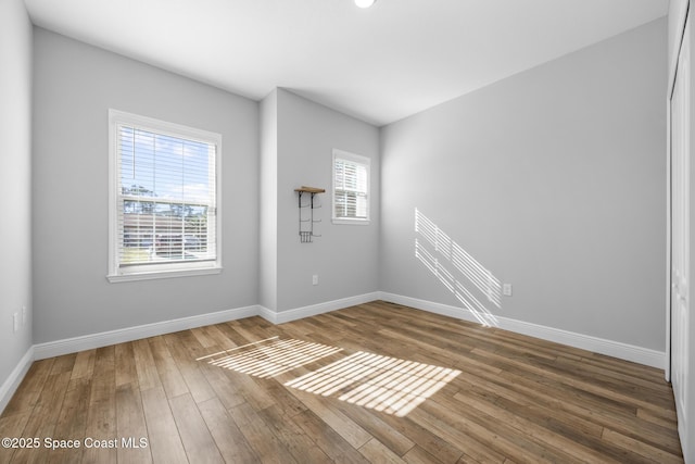 unfurnished room featuring dark wood-type flooring