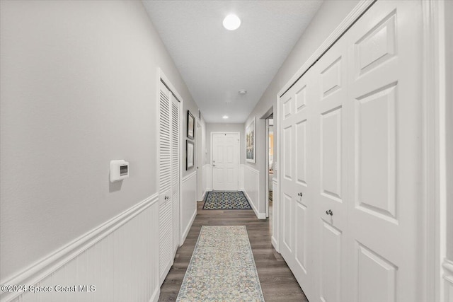 corridor with dark wood-type flooring