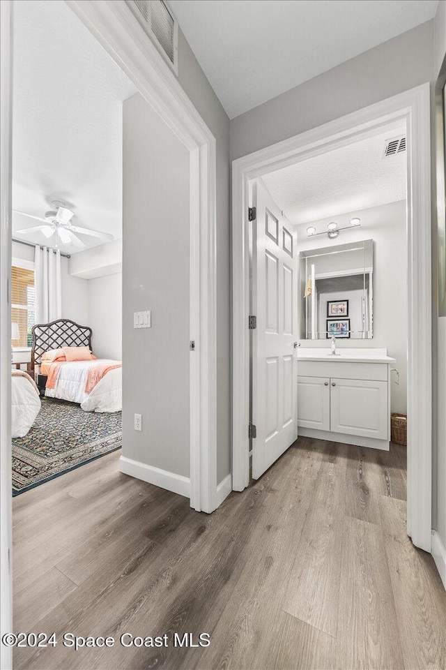 hall featuring sink and light hardwood / wood-style flooring